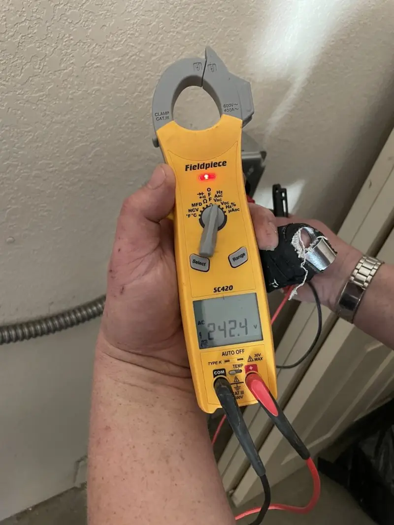 Voltage testing with clamp meter during Outlet Installation in Mussey